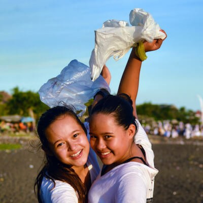 Mel Bel Holding Plastic Bags At Beach