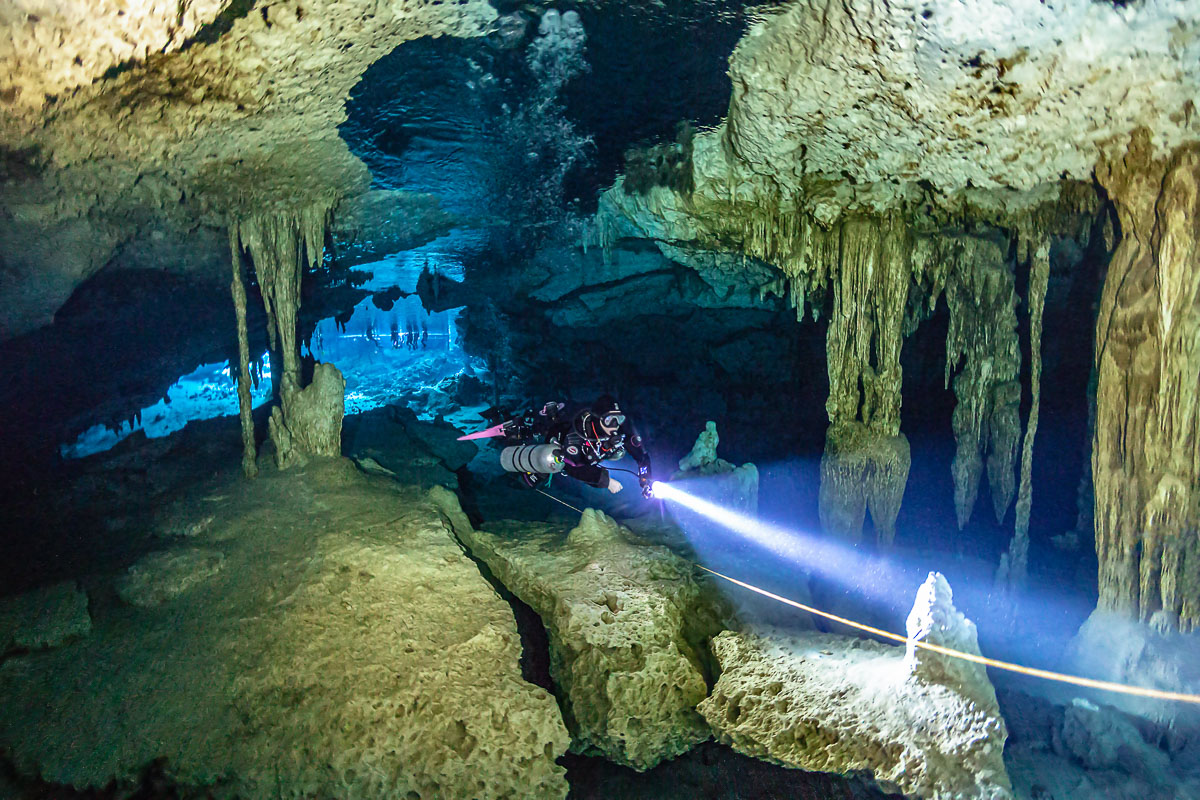 A diver entering the Dos Ojos cenotes in Mexico.