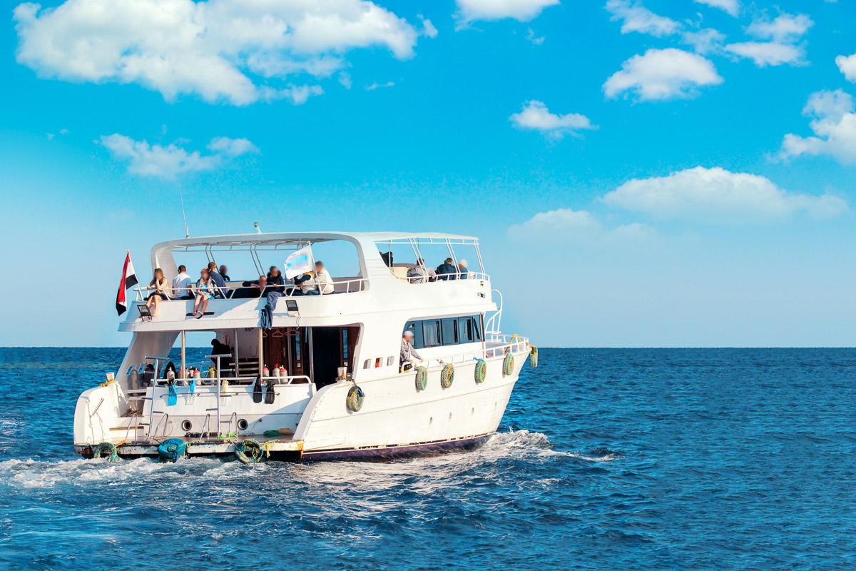 Liveaboard dive boat sailing off to its next destination in the Maldives