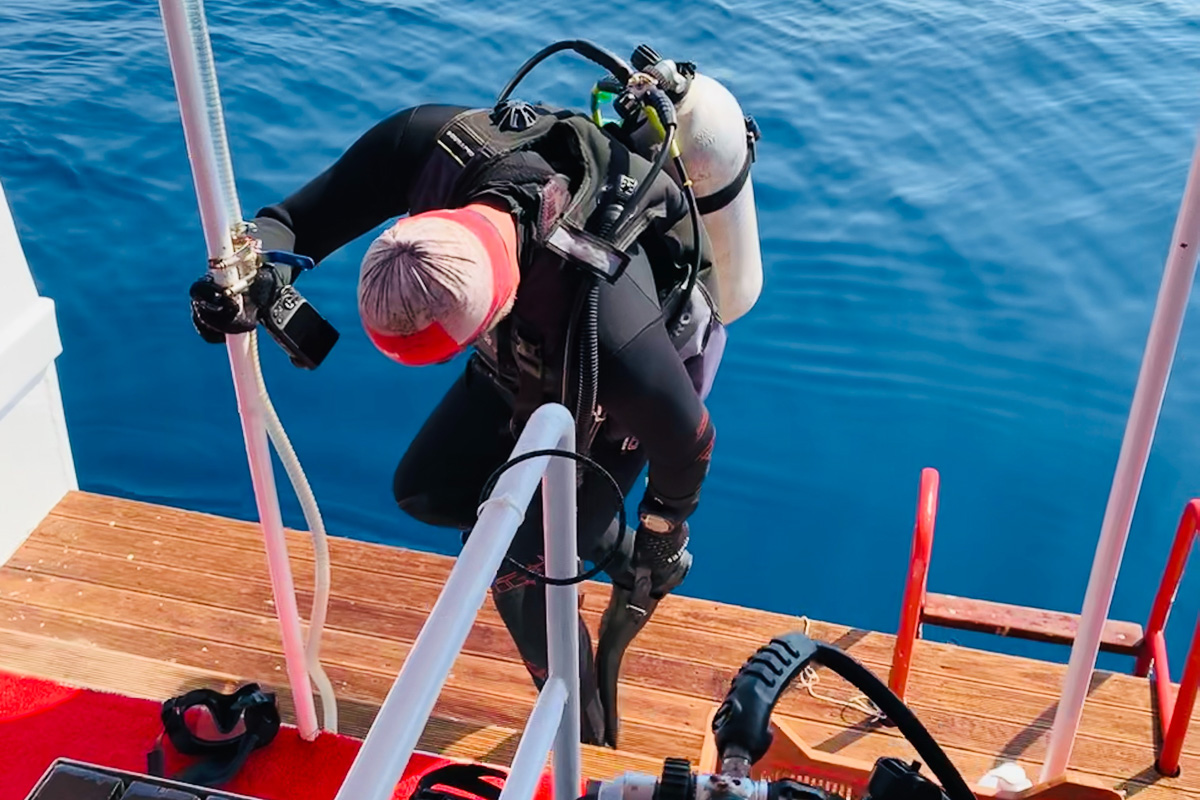 Scuba diver preparing to dive from the back of a liveaboard
