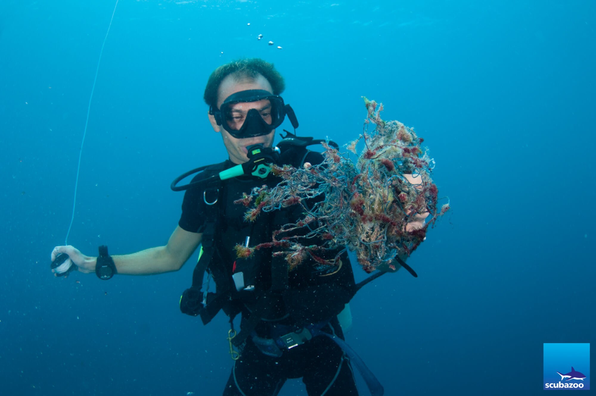 Malcolm holding some of the removed netting. © Scubazoo