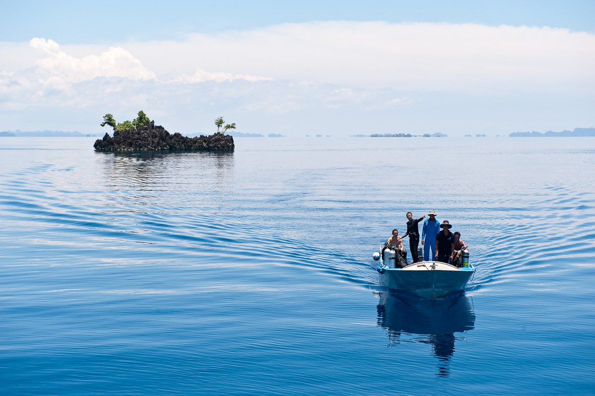 Divers returning from a dive on the aptly named Nudi Rock in Misool