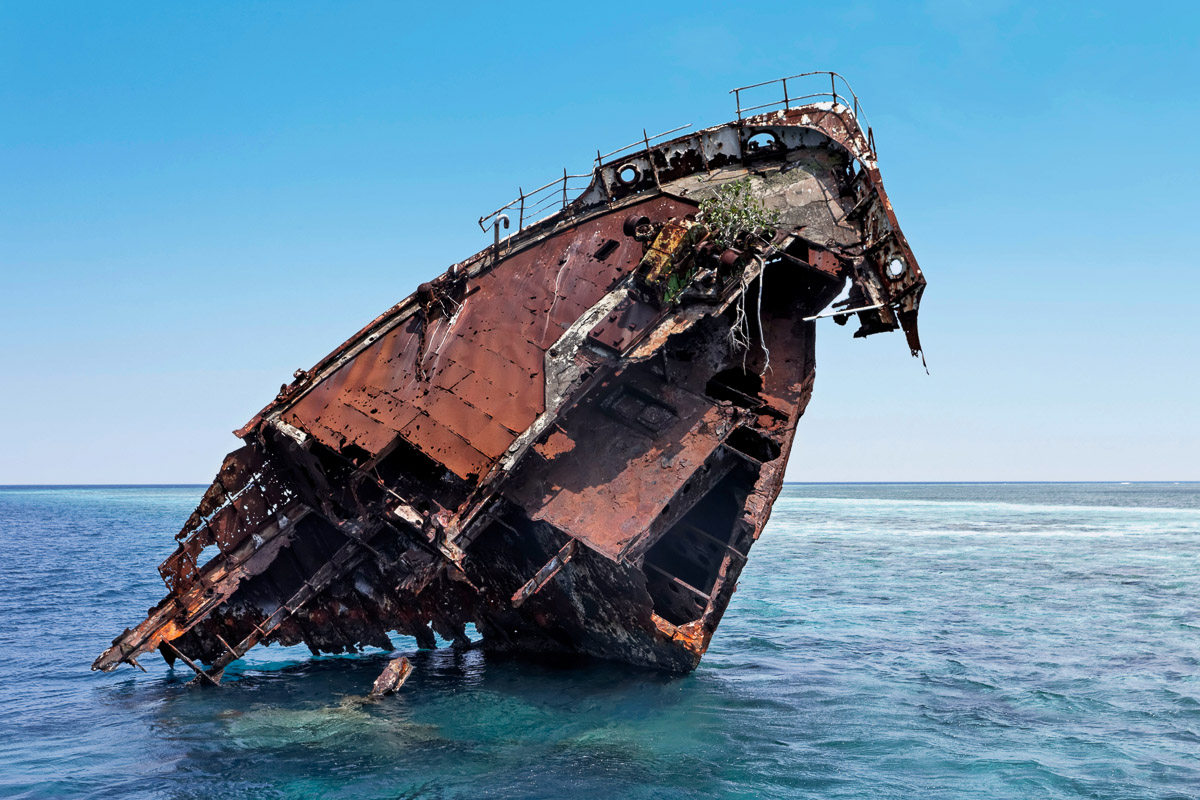 A wreck stands high out of the water at the Shipyard dive site in Lhaviyani